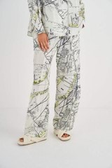 Profile view of model wearing the Oroton Map Print PJ Pant in Antique Cream and 100% Silk for Women