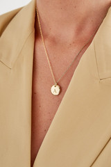 Profile view of model wearing the Oroton Sutton Alphabet Letter Necklace in Gold and Brass Base With 18CT Gold Plating for Women