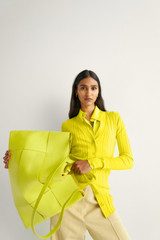 Profile view of model wearing the Oroton Long Sleeve Rib Cardi in Bright Chartreuse and 77% Viscose 23% Polyester for Women