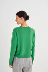 Profile view of model wearing the Oroton Long Sleeve Cashmere Crew Neck in Grass Green and 100% Cashmere for Women