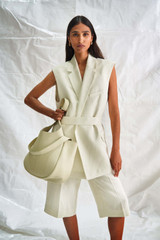 Profile view of model wearing the Oroton Long Line Vest in Marshmallow and 58% Viscose 42% Linen for Women