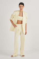 Profile view of model wearing the Oroton Pleat Detail Pant in Lemon Butter and 58% Viscose, 42% Linen for Women