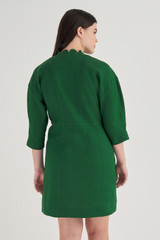 Profile view of model wearing the Oroton Short Scallop Dress in Treehouse and 100% Linen for Women