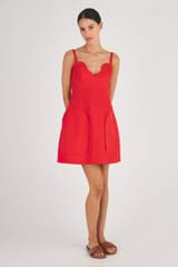 Profile view of model wearing the Oroton Short Scallop Dress in True Red and 100% Cotton for Women