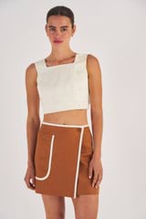 Profile view of model wearing the Oroton Contrast Bind Wrap Skirt in Brandy and 100% Linen for Women