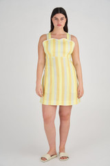 Profile view of model wearing the Oroton Stripe Apron Dress in Marigold and 100% Linen for Women