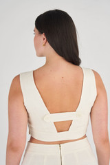 Profile view of model wearing the Oroton Fitted Bodice in Soft Cream and 100% Linen for Women