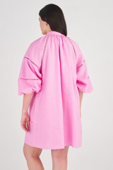 Profile view of model wearing the Oroton Ladder Stitch Smock Dress in Bright Foxglove and 100% Linen for Women
