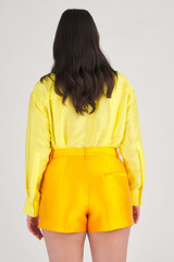Profile view of model wearing the Oroton Tailored Short in Marigold and 86% Polyester, 14% Silk for Women