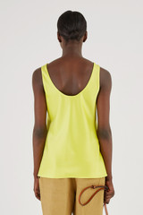Profile view of model wearing the Oroton Fluid Satin Tank in Citrine and 80% Acetate, 20% Polyester for Women