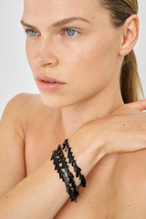 Profile view of model wearing the Oroton Vera Bracelet in Black and 100% Metal for Women