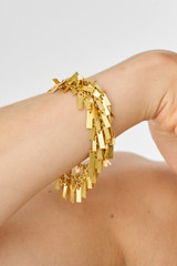 Profile view of model wearing the Oroton Vera Bracelet in Worn Gold and 100% Metal for Women