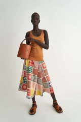 Profile view of model wearing the Oroton Quilt Print Skirt in Bone and 100% Silk for Women