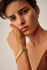 Profile view of model wearing the Oroton Jolie Bracelet in Gold and  for Women