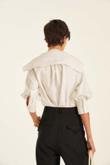 Profile view of model wearing the Oroton Scarf Blouse in Antique White and 100% Silk for Women