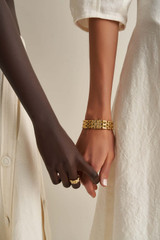 Profile view of model wearing the Oroton Kylo Bracelet in Worn Gold and  for Women