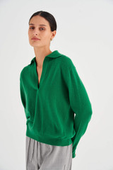 Profile view of model wearing the Oroton Relaxed Polo Top in Tennis Green and 100% Wool for Women