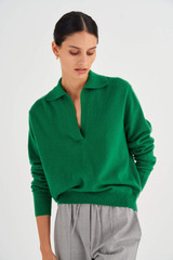 Profile view of model wearing the Oroton Relaxed Polo Top in Tennis Green and 100% Wool for Women