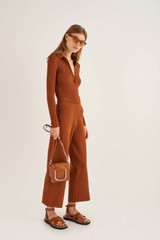 Profile view of model wearing the Oroton Knit Pant in Cognac and 83% Viscose 17% Polyester for Women