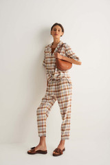 Profile view of model wearing the Oroton Check Pant in Cocoa and 70% Viscose 30% Acetate for Women