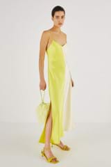 Profile view of model wearing the Oroton Fluid Satin Slip Dress in Citrine and 80% Acetate, 20% Polyester for Women