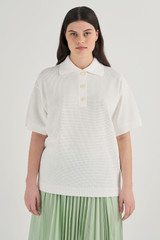 Profile view of model wearing the Oroton Mesh Stitched Polo in White and 83% Viscose, 17% Polyester for Women