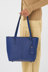 Profile view of model wearing the Oroton Lilly Small Shopper Tote in Azure Blue and Pebble Leather for Women