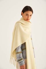 Profile view of model wearing the Oroton Wool Scarf in Lemon and 100% Lambswool for Women
