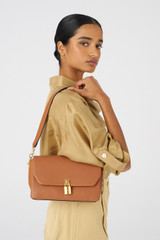 Profile view of model wearing the Oroton Tate Medium Day Bag in Brandy and Pebble Leather for Women