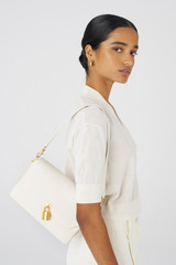 Profile view of model wearing the Oroton Tate Medium Day Bag in Paper White and Pebble Leather for Women