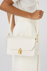 Profile view of model wearing the Oroton Tate Medium Day Bag in Paper White and Pebble Leather for Women