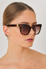Profile view of model wearing the Oroton Frankie Sunglasses in Signature Tort and Acetate for Women