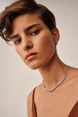 Profile view of model wearing the Oroton Felix Necklace in Worn Silver and Brass Base With Rhodium Plating for Women