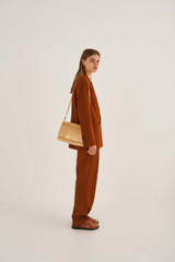 Profile view of model wearing the Oroton Heath Day Bag in Mango and Smooth Leather for Women