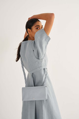 Profile view of model wearing the Oroton Jade Crossbody in Dusk Blue and Smooth Leather for Women