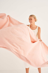 Profile view of model wearing the Oroton Kaia Towel in Sherbet and 100% Cotton for Women