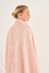 Profile view of model wearing the Oroton Kaia Towel in Sherbet and 100% Cotton for Women