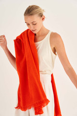 Profile view of model wearing the Oroton Kaia Towel in Apple Red and 100% Cotton for Women
