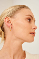 Profile view of model wearing the Oroton Elin Sleepers in Gold and Brass Base With 18CT Gold Plating for Women