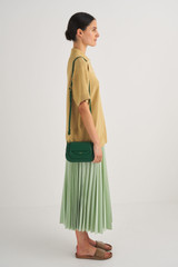 Profile view of model wearing the Oroton Haskin Crossbody in Treehouse and Smooth  Leather for Women
