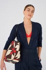 Profile view of model wearing the Oroton Boyd Quilted Tote in Dark Poppy Mix and 100% cotton twill canvas for Women
