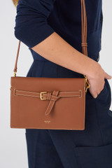 Profile view of model wearing the Oroton Margot Crossbody in Whiskey and Pebble leather for Women