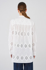 Profile view of model wearing the Oroton Diamond Lace Tunic in White and 100% Cotton for Women