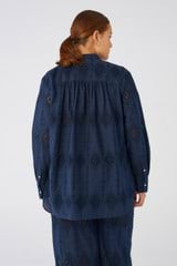 Profile view of model wearing the Oroton Diamond Lace Tunic in North Sea and 100% Cotton for Women