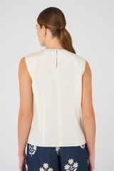 Profile view of model wearing the Oroton Silk Shell Top in Vanilla Bean and 92% silk, 8% Spandex for Women