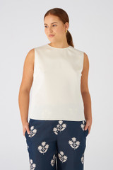 Profile view of model wearing the Oroton Silk Shell Top in Vanilla Bean and 92% silk, 8% Spandex for Women