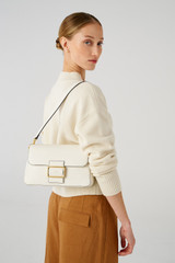 Profile view of model wearing the Oroton Astrid Shoulder Bag in Cream and Pebble leather for Women