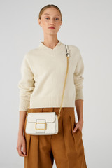 Profile view of model wearing the Oroton Astrid Crossbody in Cream and Pebble leather for Women