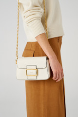 Profile view of model wearing the Oroton Astrid Crossbody in Cream and Pebble leather for Women