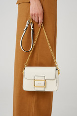 Profile view of model wearing the Oroton Astrid Crossbody in Cream and Pebble leather for Women